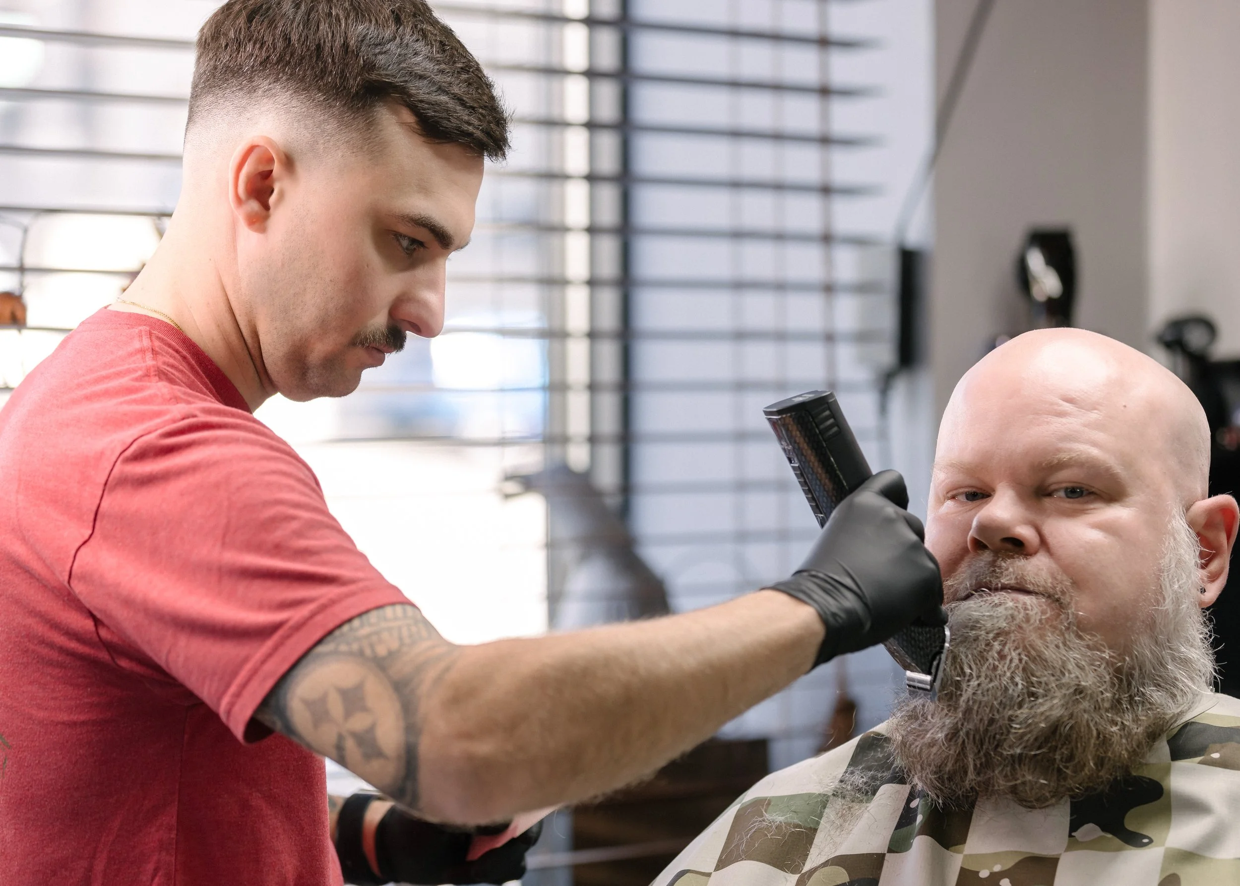 Barber working on a beard at Barbiere